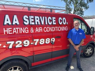 Plumbing repair service fixing a leaking kitchen pipe